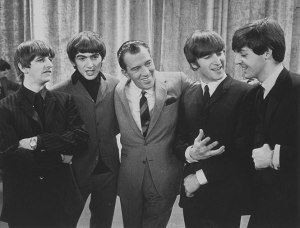 The Beatles with host Ed Sullivan in 1964